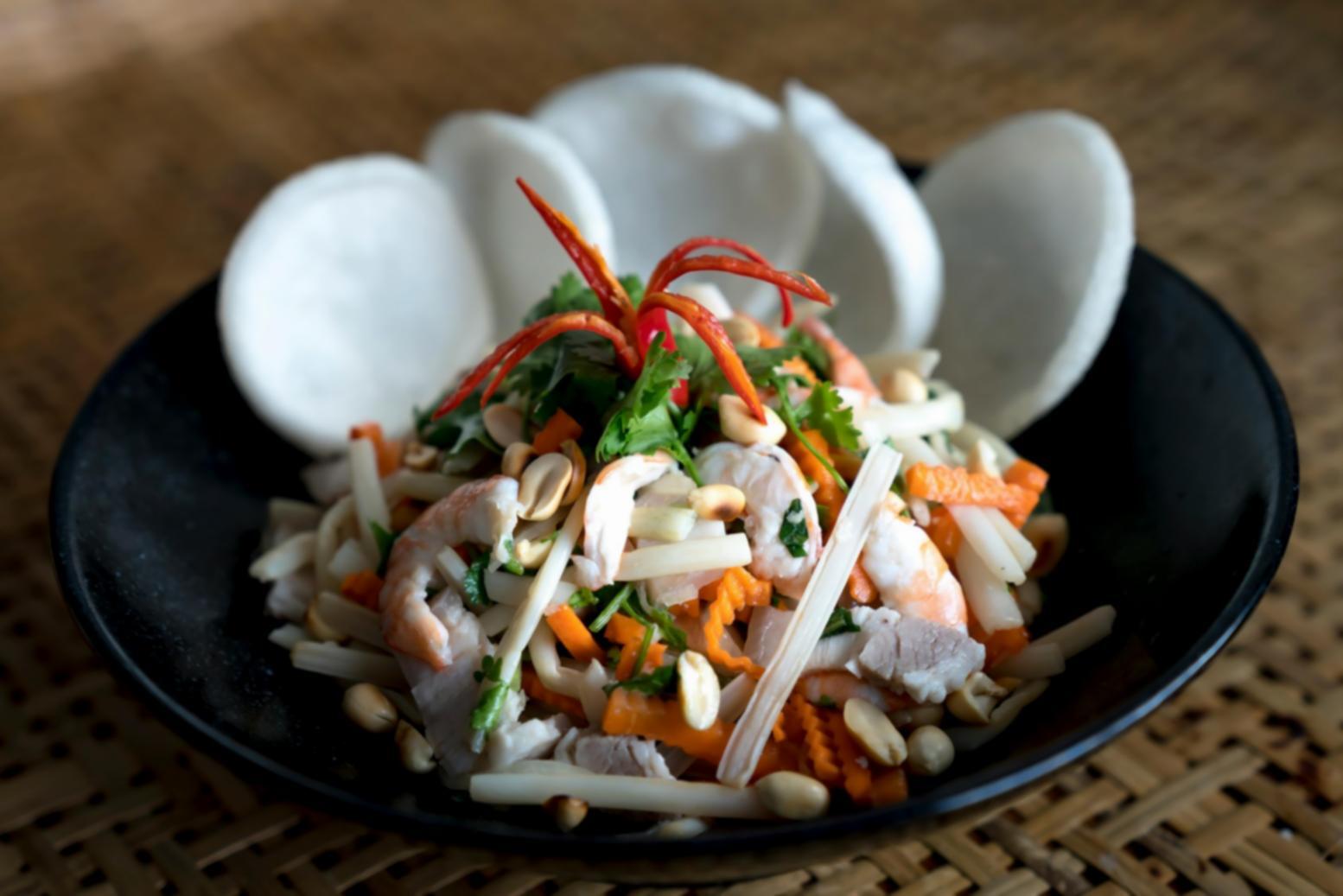 International cooking students practicing healthy meal preparation techniques
